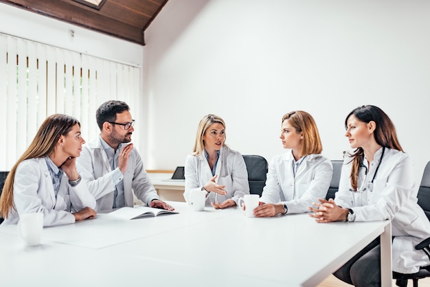 Successful medical doctors discussing diagnosis during the conference.