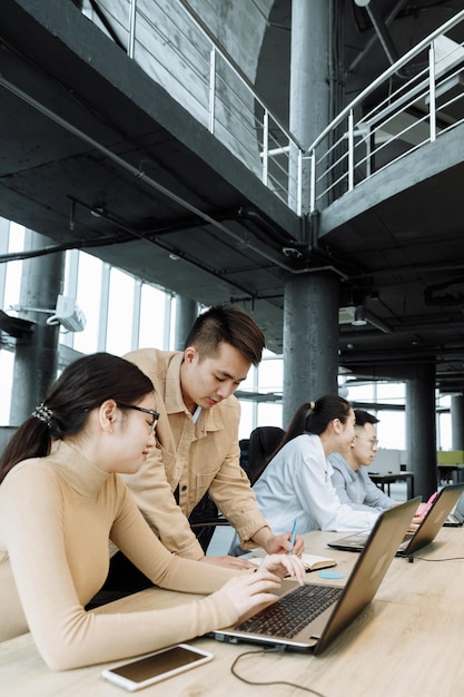 Successful older businessman with his team working at modern office