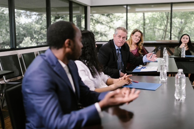 Successful older businessman with his team working at modern office