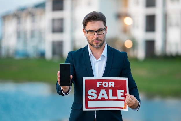 For Sale Real Estate Sign In Front Of New House Stock Photo