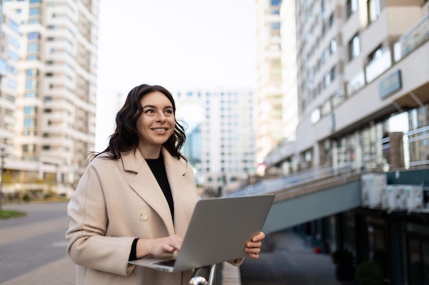 Successful selfconfident modern woman entrepreneur with a laptop in her hands works online in it