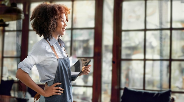 Photo successful small business owner beautiful black skin girl with apron holding tablet standing in coffee shop restaurant portrait of latin woman barista cafe owner