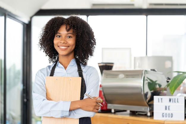 successful small business startup small business owner sme beauty girl standing in front of a coffee shop with her arms crossed picture of an asian female barista cafe owner
