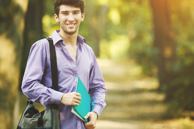 Successful student with books in the Park on a Sunny day