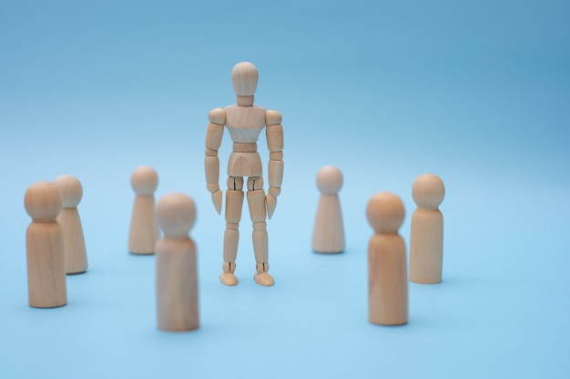 Successful team leader, Wooden people standing out from the other.