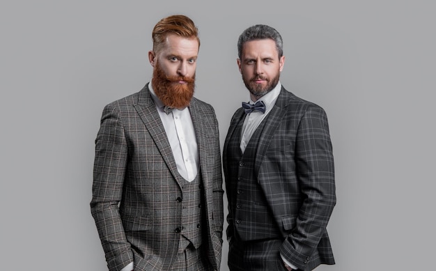 successful two men in tux studio shot of men wearing tux elegant men in formal tux suit tux men isolated on grey background