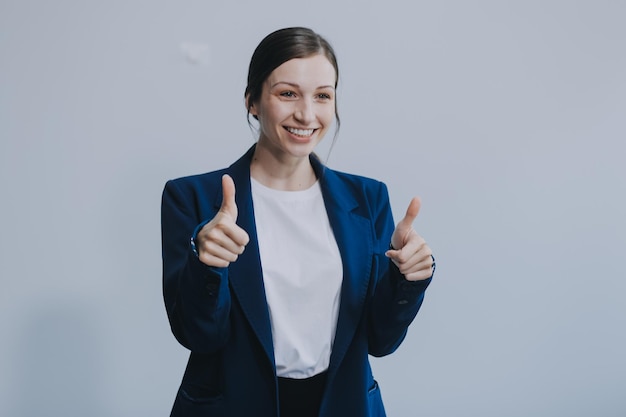 Successful young asian businesswoman in suit ready do business cross arms confident and smiling Female entrepreneur determined to win Happy saleswoman talking to clients white background