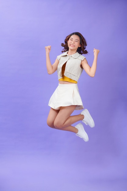 Successful young attractive laughing woman jumping up