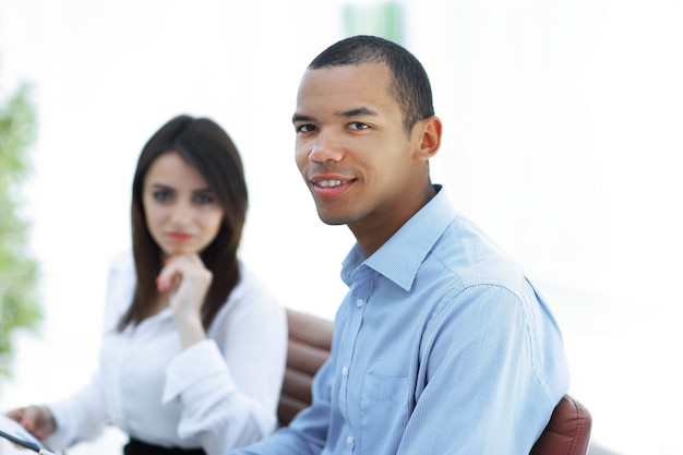 Successful young business men with financial document on the background of the office