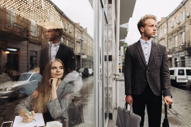 Successful young businessman and a businesswoman in a cafe