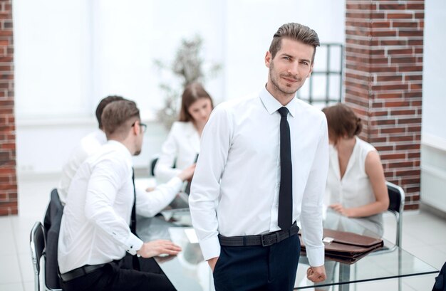 Successful young businessman standing in the office