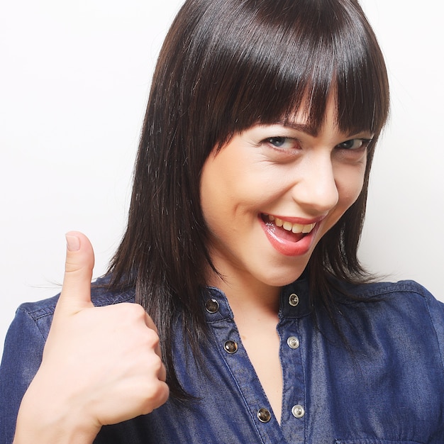 Successful young girl gives thumb up with two hands