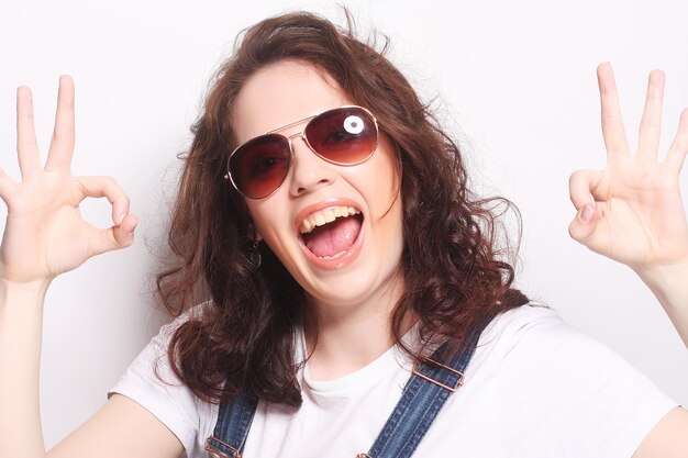 Successful young girl gives thumb up with two hands