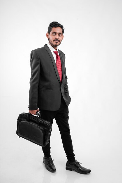 Successful Young indian business man posing o