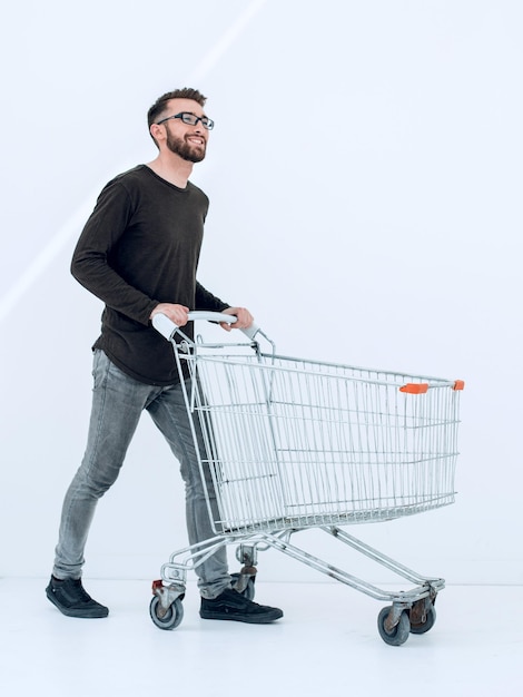 Successful young man with a shopping cart