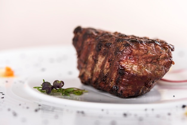 Succulent beef tenderloin steak,  served with butter with herbs, decorated with radish