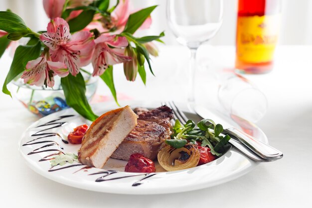 Succulent thick juicy portions of grilled fillet steak served with tomatoes and roast vegetables