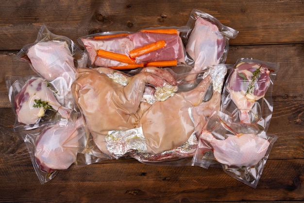 Suckling pig duck leg eyeround vacuum packed on wooden background