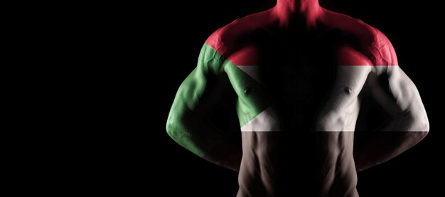 Sudan flag on muscled male torso with abs, black background