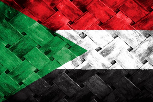 Sudan flag screen on wicker wood background