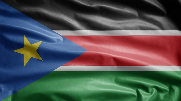 Photo sudanese flag waving in the wind. close up of south sudan template blowing, soft and smooth silk.