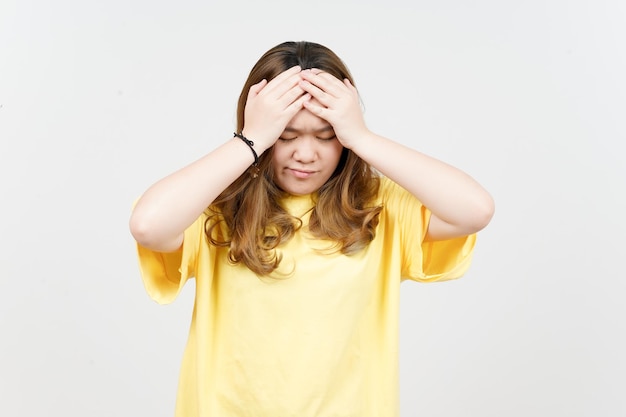 Suffering Headache of Beautiful Asian Woman wearing yellow TShirt Isolated On White Background