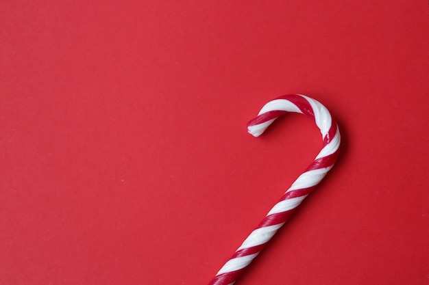 Sugar candy cane on red background