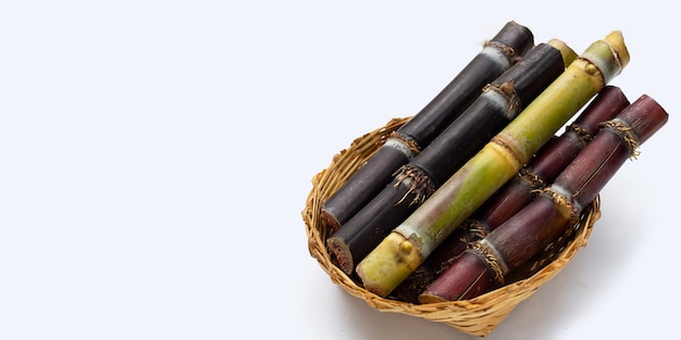 Sugar cane in bamboo basket on white background.