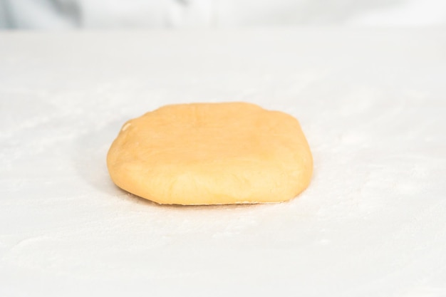 Sugar cookie dough ready to be rolled on the table.