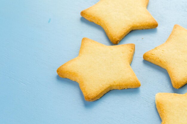 Sugar cookies in shape eof stars on blue background.