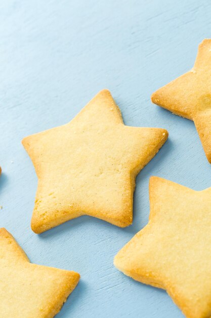 Sugar cookies in shape eof stars on blue background.