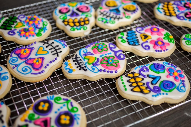 Sugar cookies in shape of sugar skull decorated with colorful royal icing for DÃÂ­a de Muertos-Day of the Dead holiday.