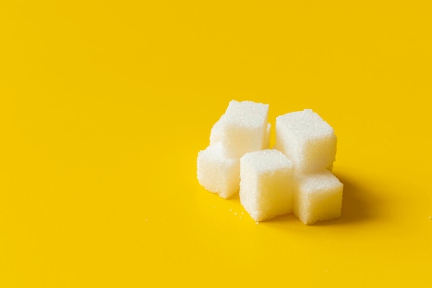 Sugar cube on yellow background isolated design mockup b