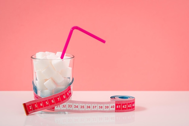 Photo sugar cubed in glass with tape measure