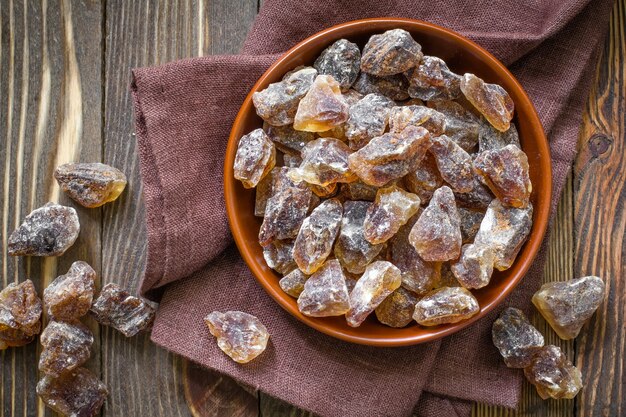 Sugar cubes in a bowl on wooden table