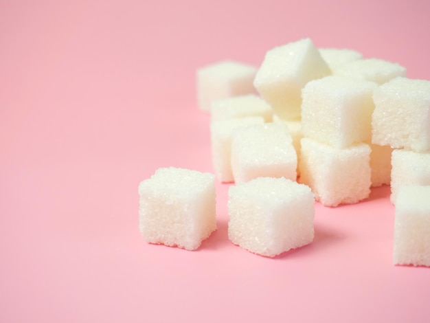 Sugar cubes on isolated pink background