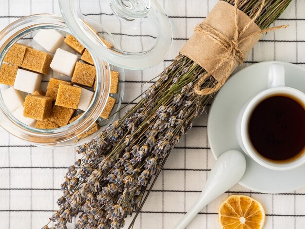 Sugar cubes in jar and bouquet of lavender