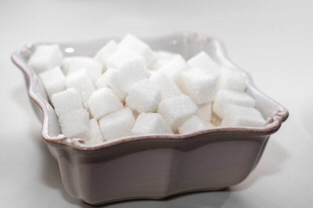 Sugar cubes in a white square bowl