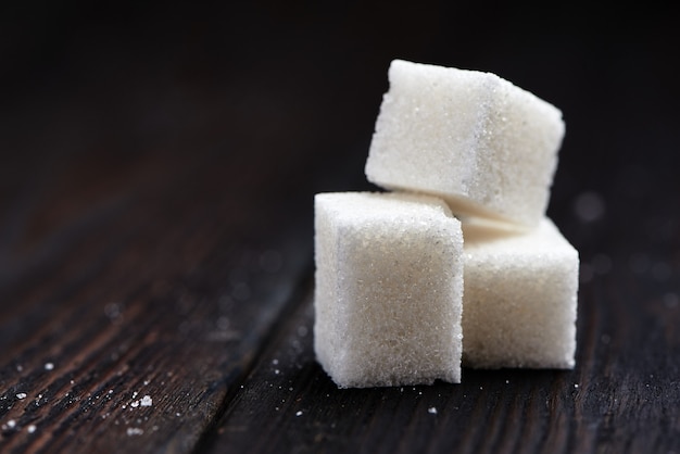 Sugar cubes on a wooden background