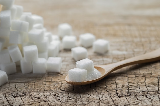 sugar in cup on wooden table