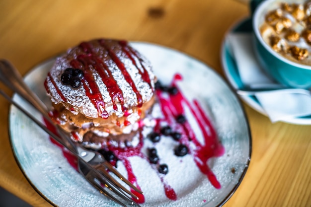 Sugar dessert pan cakes with berries and jam Breakfast concept