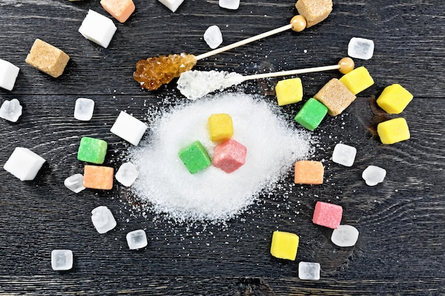 Sugar of different colors and shapes on board top