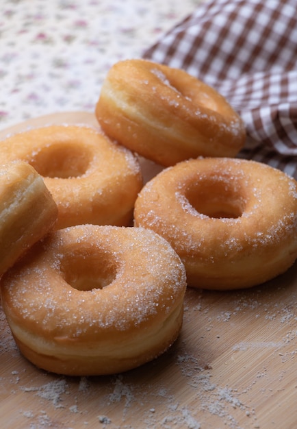 Sugar donuts on wooden board