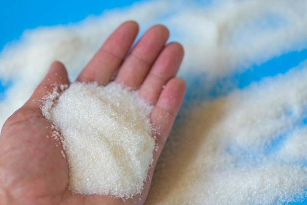 Sugar on hand background white sugar for food and sweets dessert candy heap of sweet sugar crystalline granulated