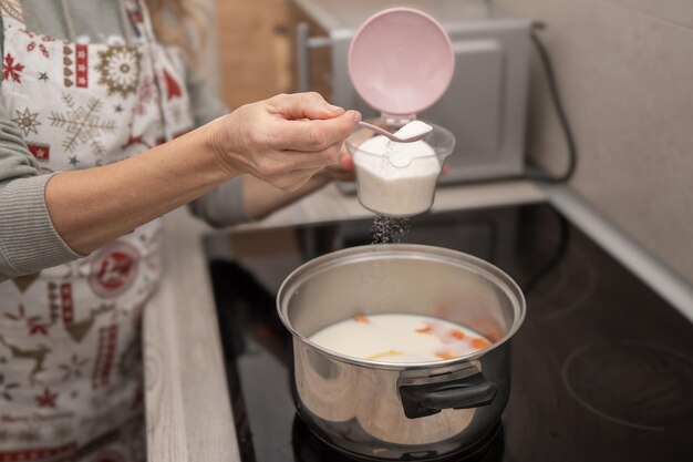 Sugar is added to milk with orange and lemon