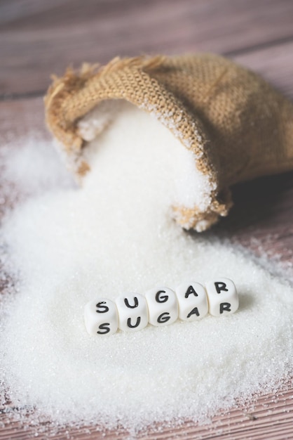 Sugar on sack and wooden background white sugar for food and sweets dessert candy heap of sweet sugar crystalline granulated