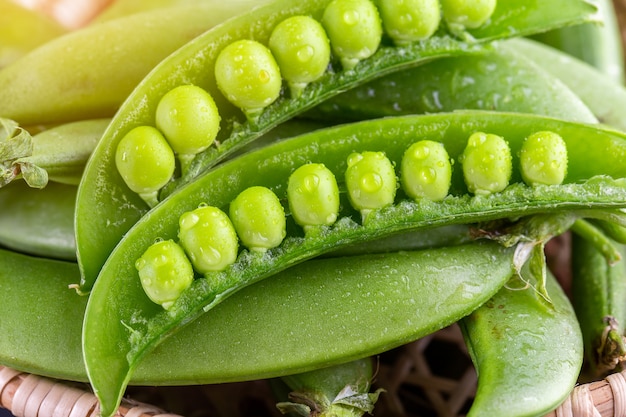 Sugar snap peas with mint on a rustic wood background