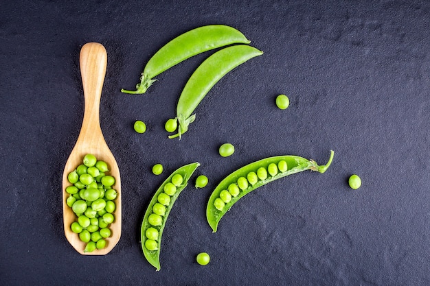 Sugar snap peas with mint on a rustic wood background