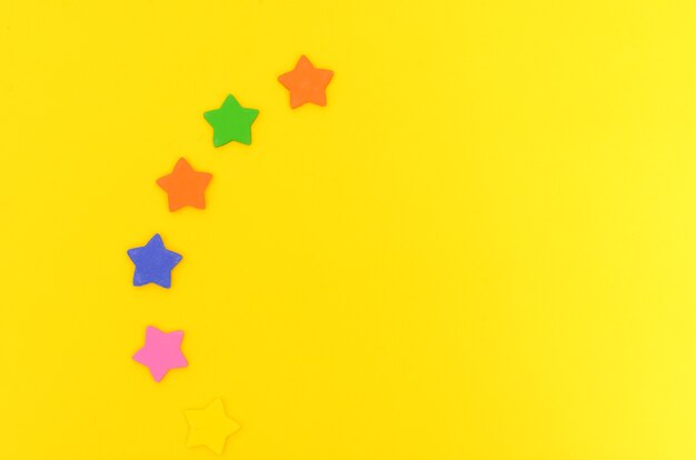 Sugar stars on yellow background Colorful stars