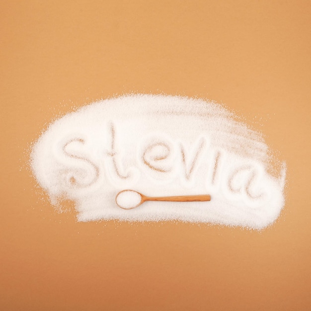 Sugar substitute in wooden scoop Scattered stevia sweetener Stevioside powder Food additive E960